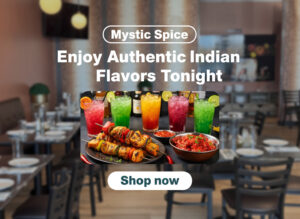 Mystic Spice restaurant interior with colorful drinks and sizzling Indian kebabs on a plate, highlighting the vibrant dining experience.