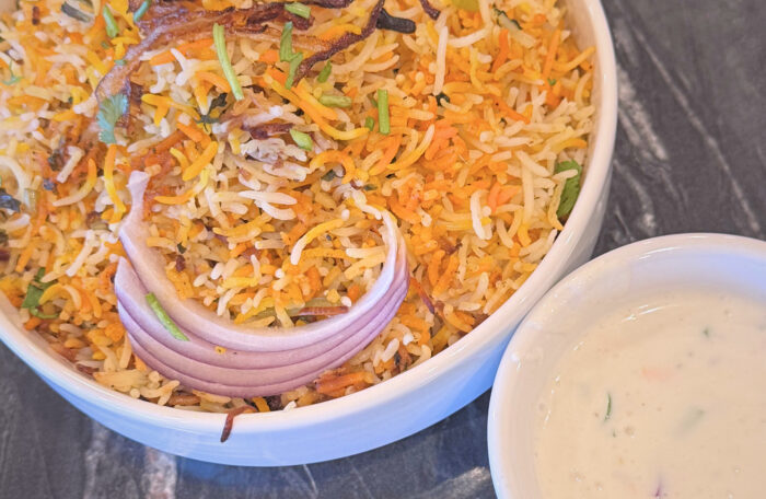 Layered chicken biryani with aromatic spices